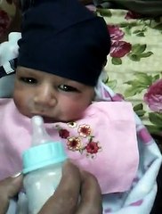 funny cute baby drinking milk first time