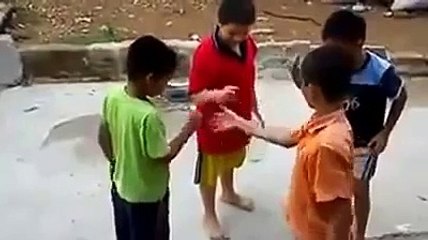 Little kids play rock paper scissors with a bottle.