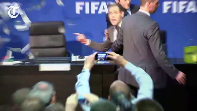 Sepp Blatter showered with banknotes as prankster Lee Nelson storms Fifa press conference
