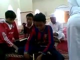 child crying and reading the Quran