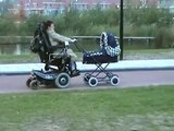Pushing a stroller in a wheelchair.