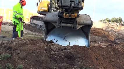 Volvo EC 380 DL excavator finds a cable under the ground in 2014