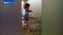 Talented boy goes fishing with a toy pole and catches a fish