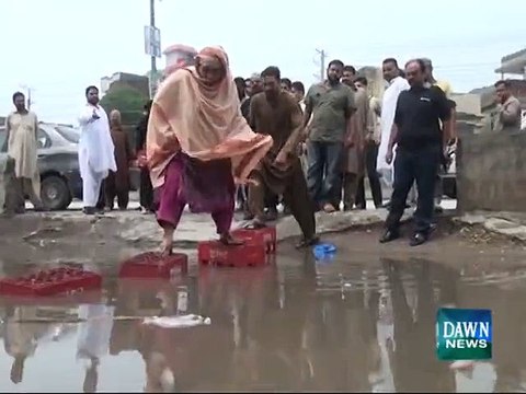 Man falls in rain water outside polling station in Gujranwala