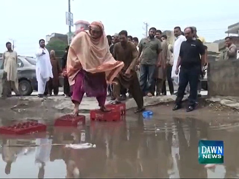 Man falls in rain water outside polling station in Gujranwala