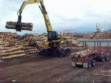 caterpillar 325 unloading logging truck