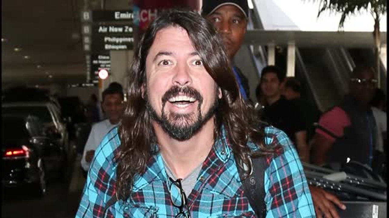 Foo Fighters Dave Grohl Wheels Through LAX With Broken Leg