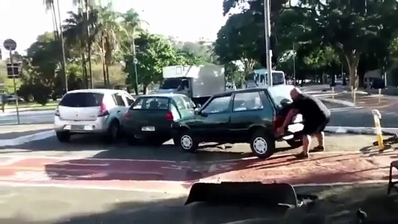 Watch incredible moment angry cyclist lifts CAR out of bike lane as pedestrians cheer wild