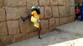man climbing like an animal on wall