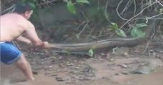 Strong Man trying to catch Python - Amazing