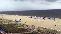 Windy Day At The Beach Sends Countless Umbrellas Flying