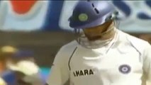 Dravid raises his bat after scoring a single