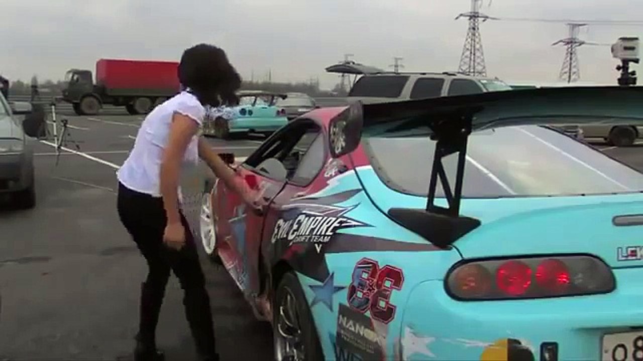 Son chemisier explose avec l'accélération de la voiture de course