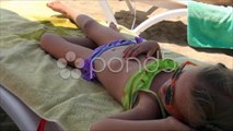 Little Girl in Sea Sand Beach, Coastline, Child Sunbathing on Seashore, Children. Stock Footage