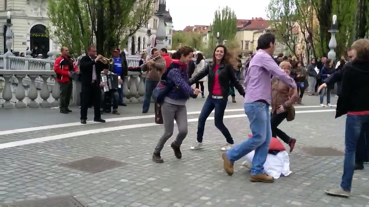 Street musicians in Ljubljana, Slovenia playing balkan music, people dancing