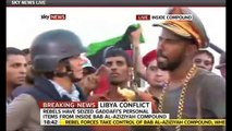 Libyan wears Gaddafi's hat