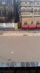A man saves a child from floods in Yemen