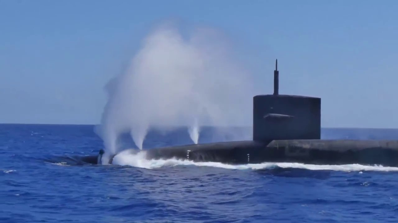 US Submarine Diving Like a Whale Next to Dolphins