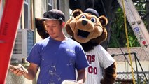 MN Twins mascot TC helps with painting instructions for Twin Cities Habitat