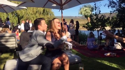 Man swipes bridal bouquet away from his girlfriend