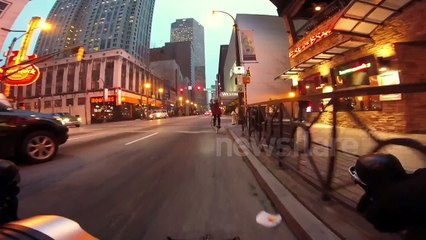 Girl on bike gets welcoming theme music from busking trumpet player