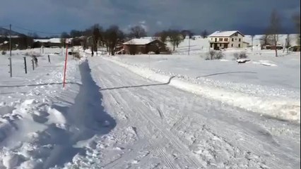Man snowboards behind a horse