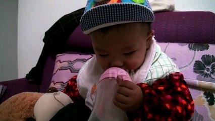 Cute baby trying to stay awake while eating