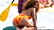 (VIDEO) Rihanna Sizzles In Yellow Swimsuit While Paddle Boarding