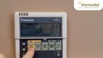 How to change the time and day on a Daikin air conditioning controller