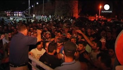 Syria refugees begin boarding Greek passenger ship in Kos