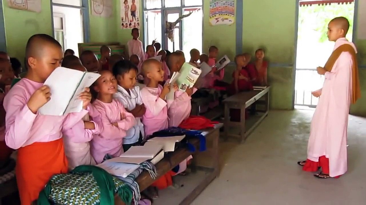 Burma Buddhist nun teacher, wielding cane and corporal punishment