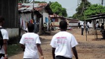 Oxfam Community Health Volunteers go door-to-door to help prevent Ebola