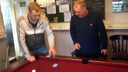 Magician performs card trick on pool table