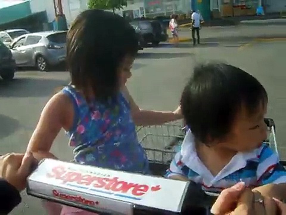 cute baby having FUN riding on a shopping cart
