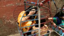Cute children celebrate Eid festival with small ferris wheel rides