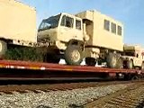 Super Long train carrying dozens of tanks and other millitary vehicles....
