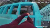 Russian daredevil hanging from a 40-storey building without safety gear..