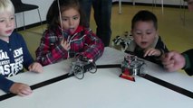 Young kids playing with robotic toy (robot for education University of Technology Twente Netherland)