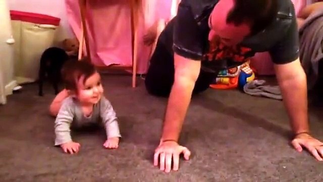 A dad teaches his 7 month old daughter to surf