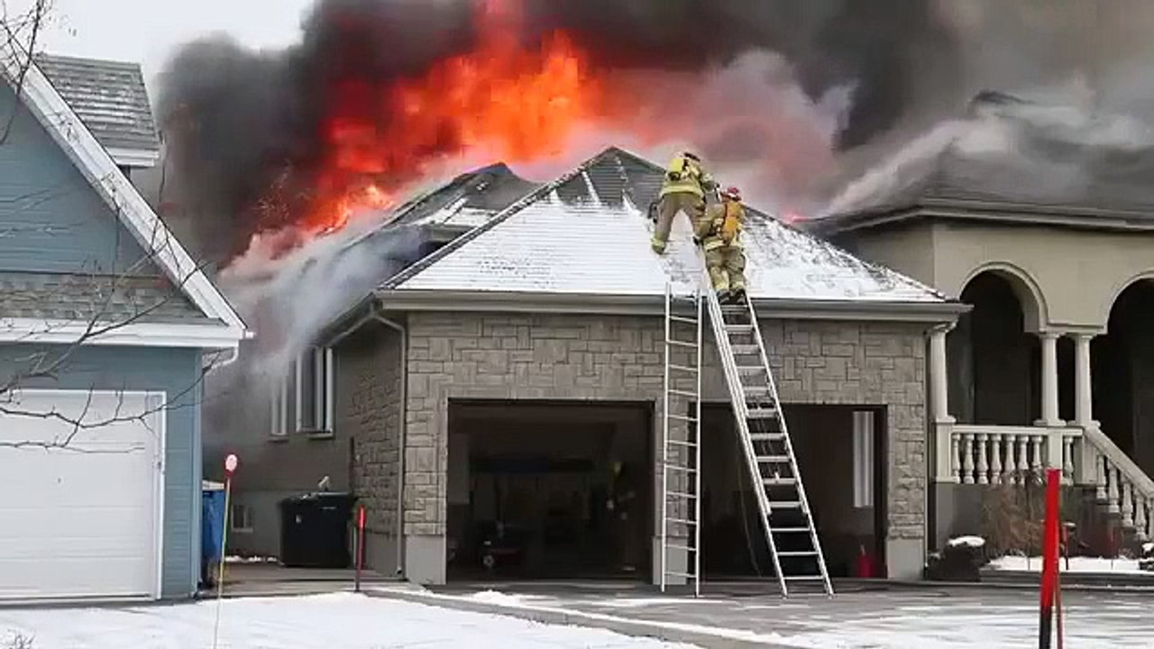 Firefighters fall off ladder at house fire.