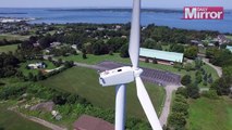 Drone spots man sunbathing on wind turbine
