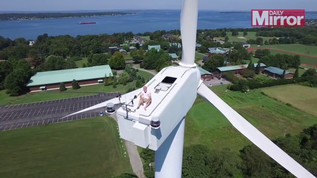Drone pilot spots man sunbathing on top of wind turbine 200f