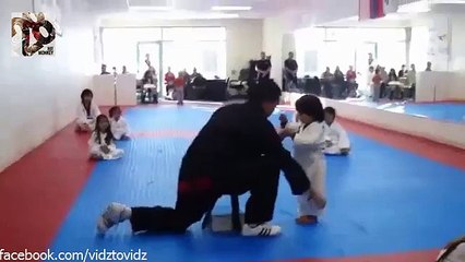 Cute child tries to interrupt a board in Taekwondo, however fails adorably!