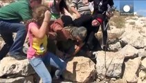 Palestinian women and children force Israeli soldier to release boy