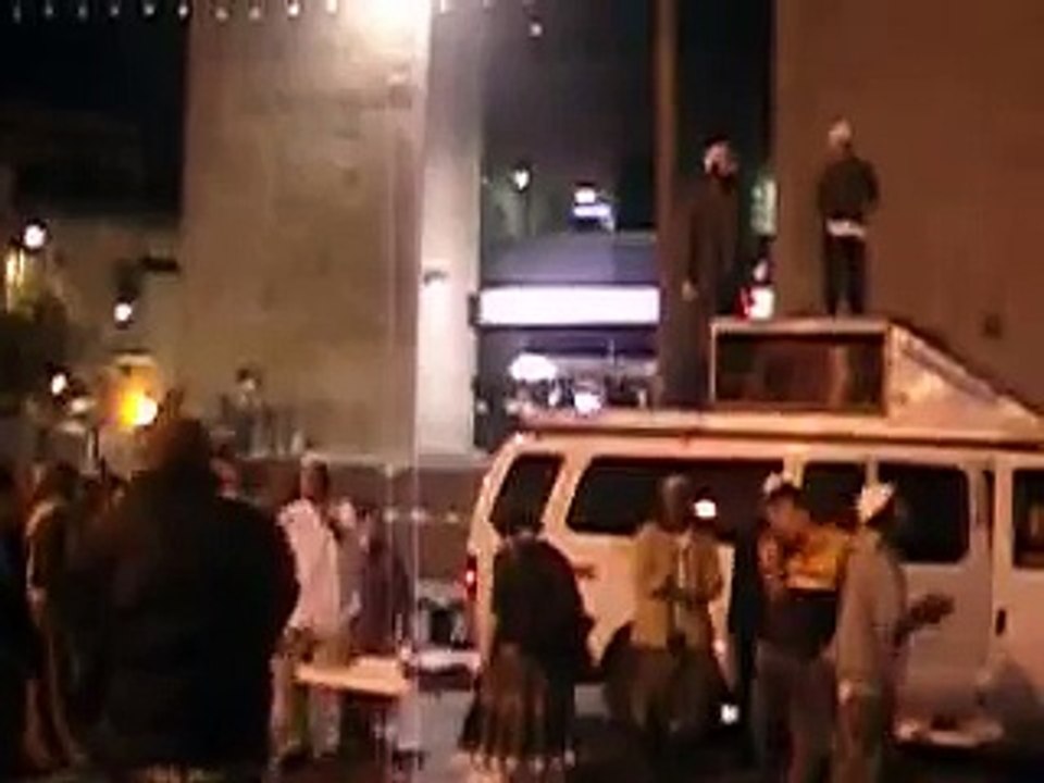 nachman guy dancing on top of a car with his kid