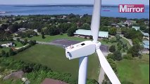 Drone pilot spots man | sun bathing on top of wind turbine 200feet above ground |