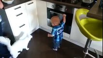 Cat stops baby from opening oven