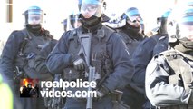 4K UHD - Police officer with weapon standing by behind line of riot cops