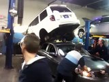 SUV Falls Off Hoist Onto Other Car - FAIL!