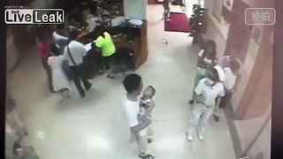 Man with baby in arm kicks nurse in butt